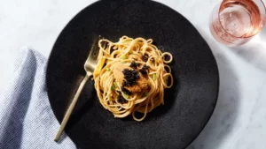 caviar pasta on a black plate